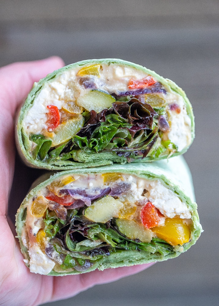 close up of roasted vegetable hummus wraps cut in half