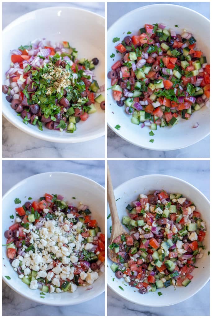 Greek salad being mixed together in a bowl