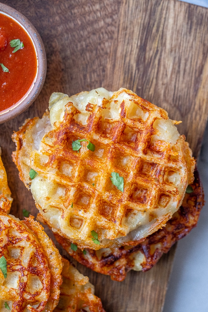 close up of cheesy gnocchi waffles with marinara sauce