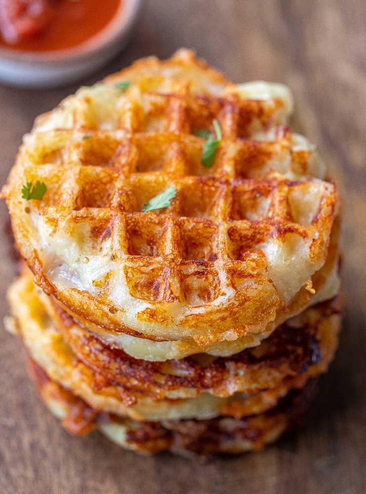 stack of cheesy gnocchi waffles with marinara