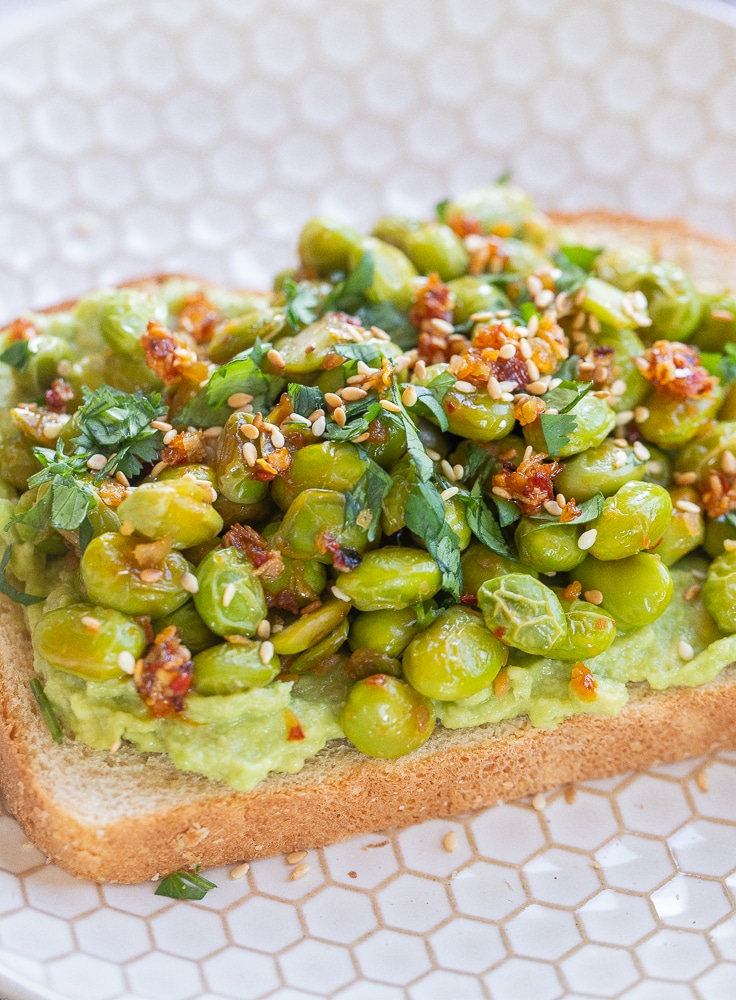 close up of edamame avocado toast on a plate