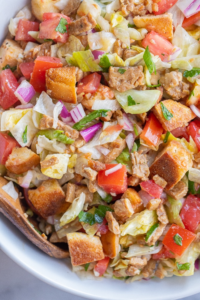 Close-up of vegan BLT salad with crusty bread