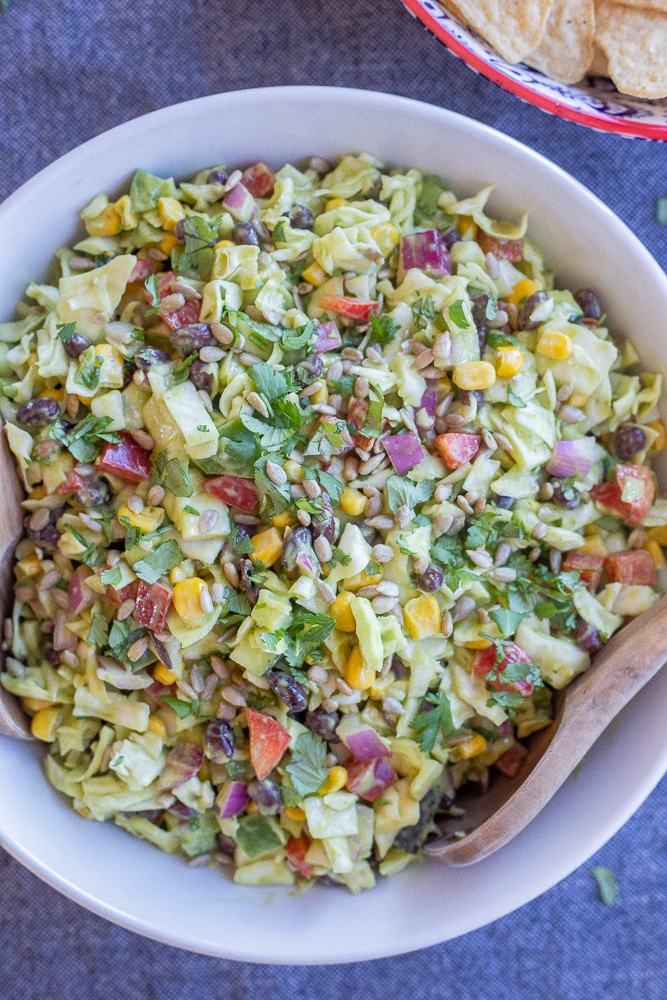 big bowl of creamy southwestern chopped cabbage salad with tortilla chips