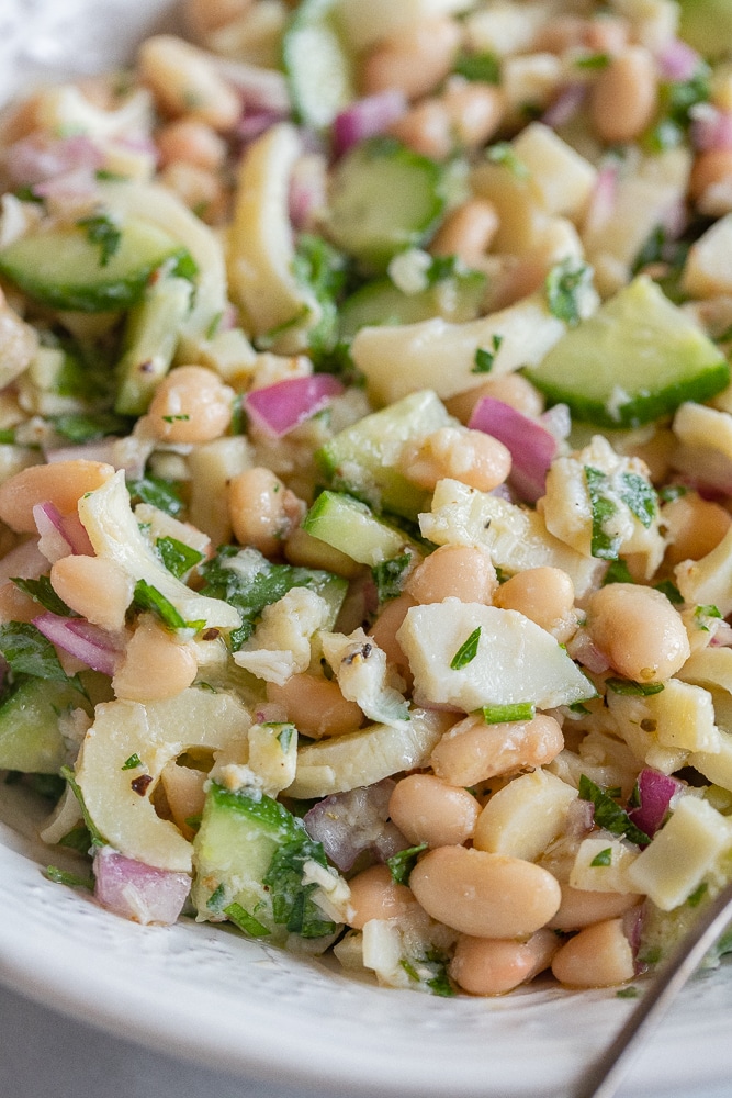 close up of a bowl of heart of palm salad with white beans