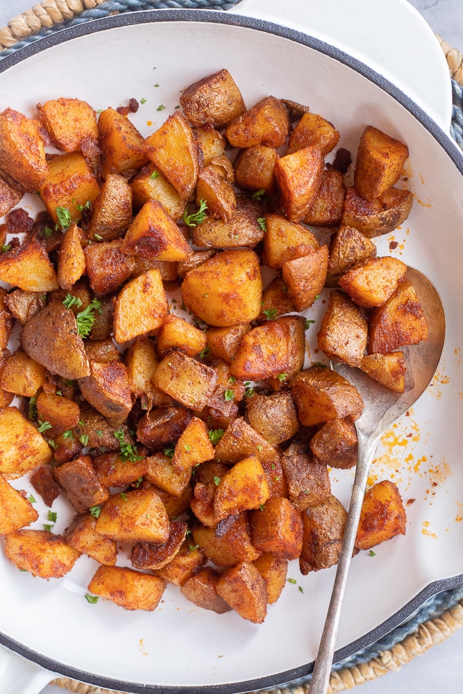 home fries in a pan with a spoon