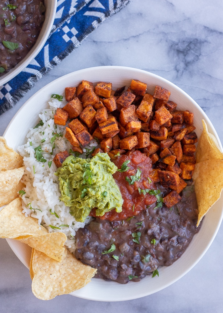 roasted sweet potato and black bean burrito bowls with rice, guacamole and salsa