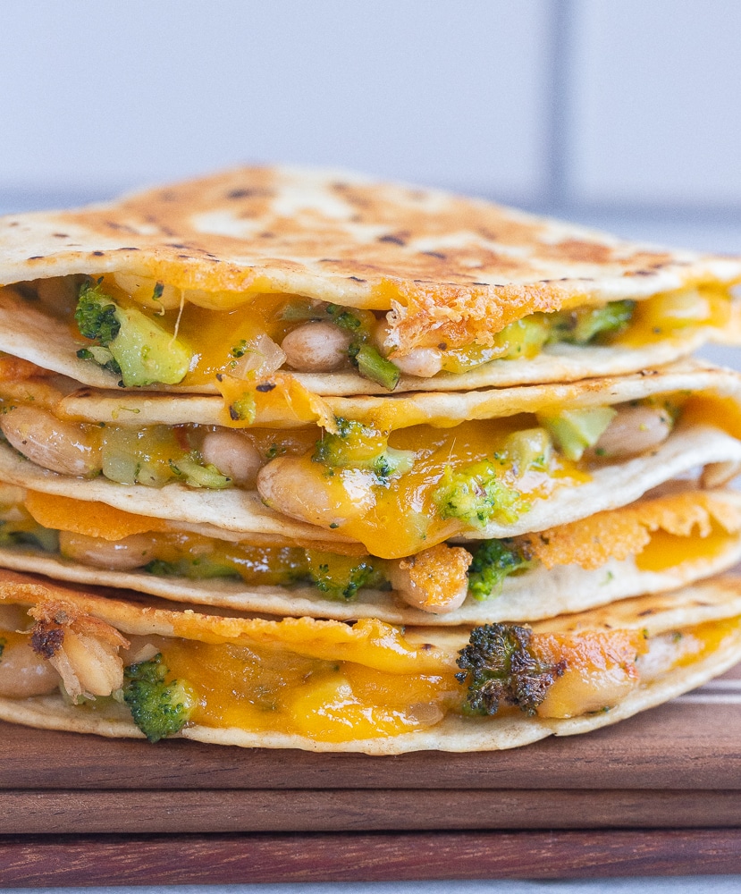 broccoli cheddar and white bean quesadillas stacked on top of each other 