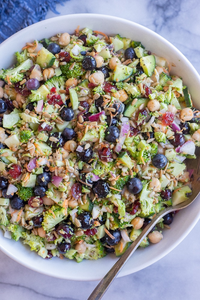 Broccoli Blueberry Salad with Chickpeas in a serving bowl with a spoon
