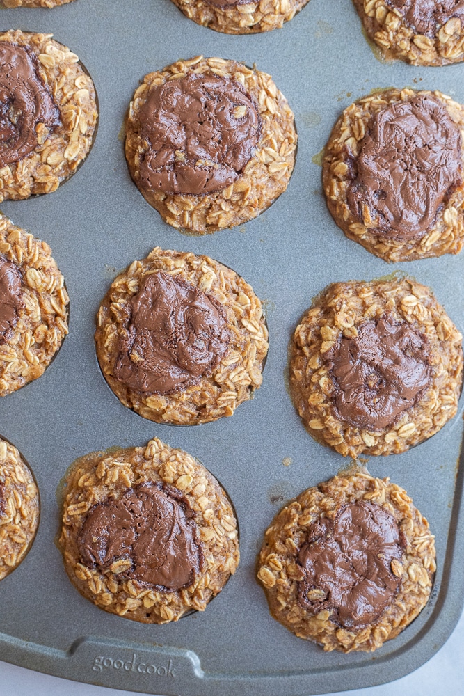 nutella banana oatmeal muffins in a muffin tin after coming out of the oven