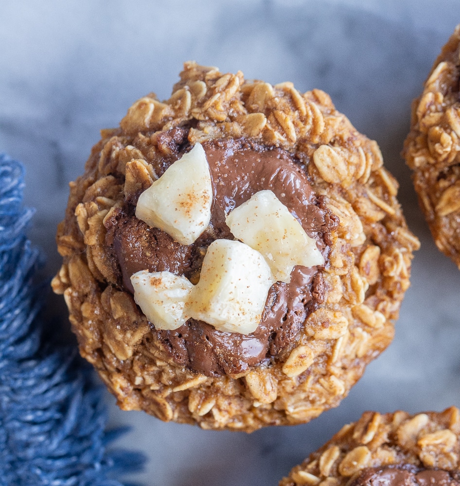 close up of a nutella banana bread oatmeal muffin with chopped bananas on top