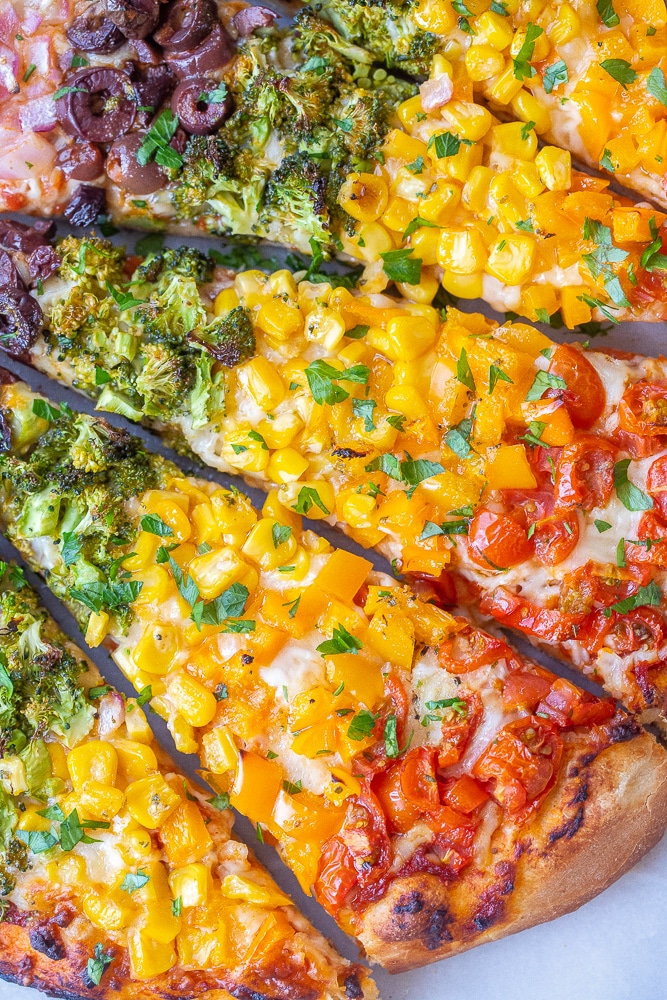 close up of a slice of rainbow vegetable pizza