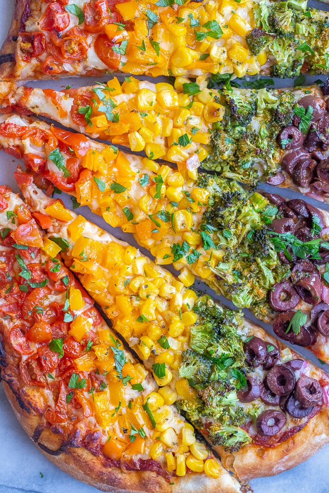 rainbow veggie pizza cut into slices