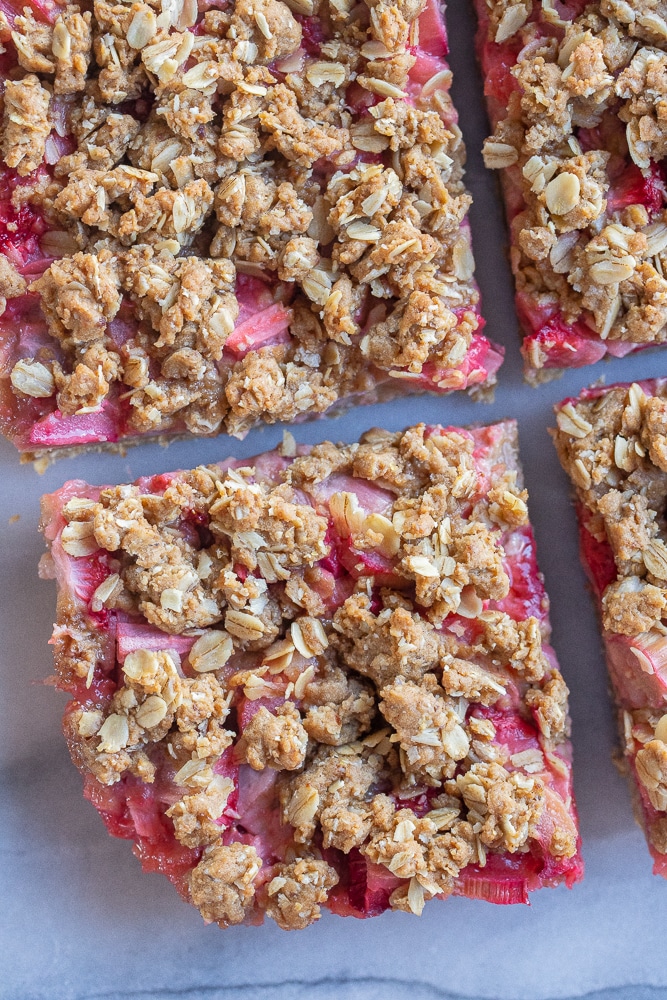close up of a slice of strawberry rhubarb crumble bars