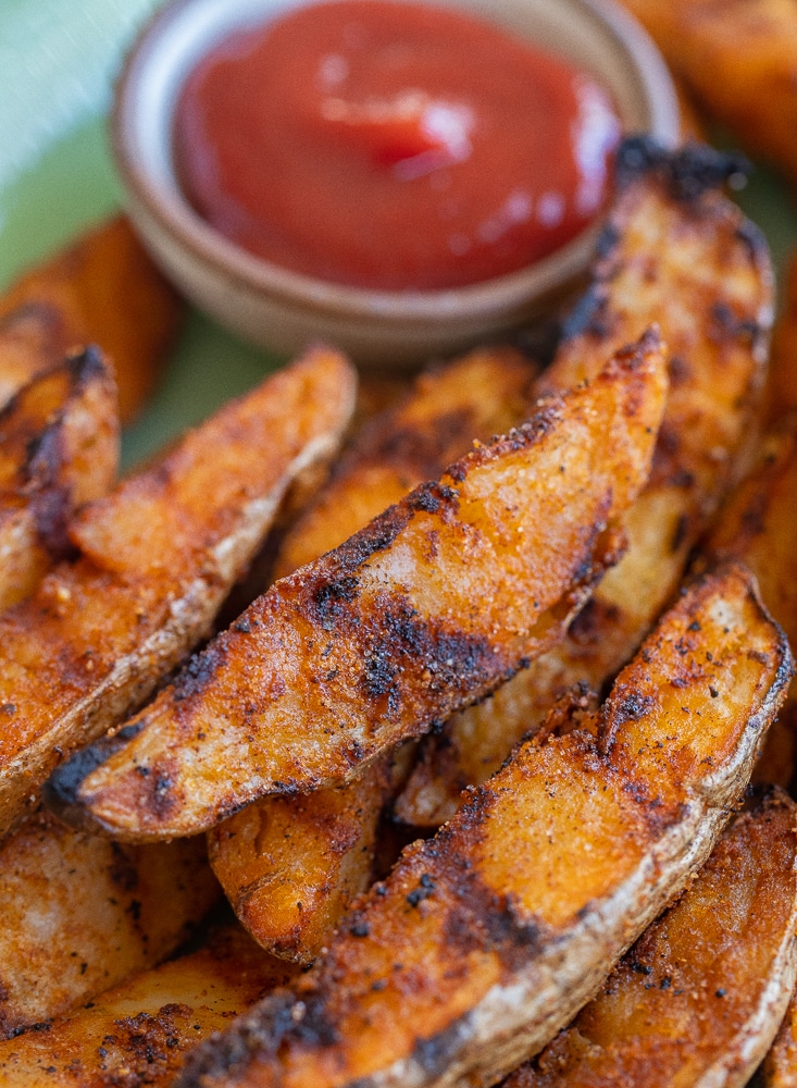 close up of a grilled potato wedge on a plate