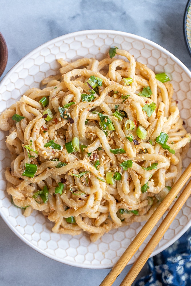easy ginger tahini noodles in a bowl with chopsticks