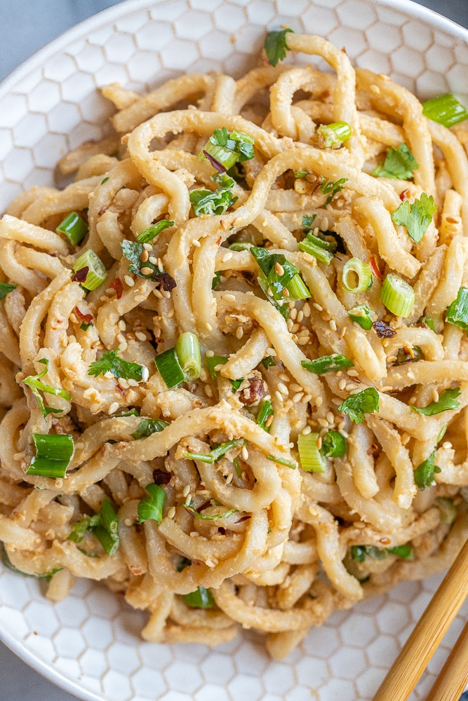close up of a bowl of creamy ginger garlic tahini noodles