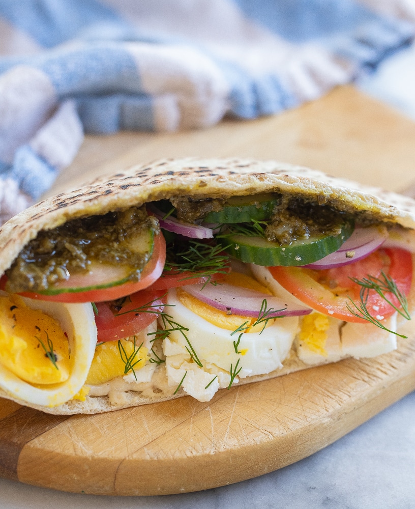 a vegetarian breakfast pita on a cutting board