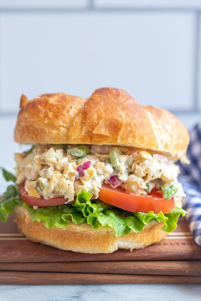 close up of a vegetarian tuna salad croissant on a cutting board