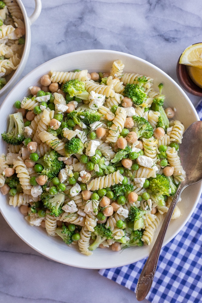 Lemon Broccoli Pasta Salad in a serving bowl with a spoon and napkin