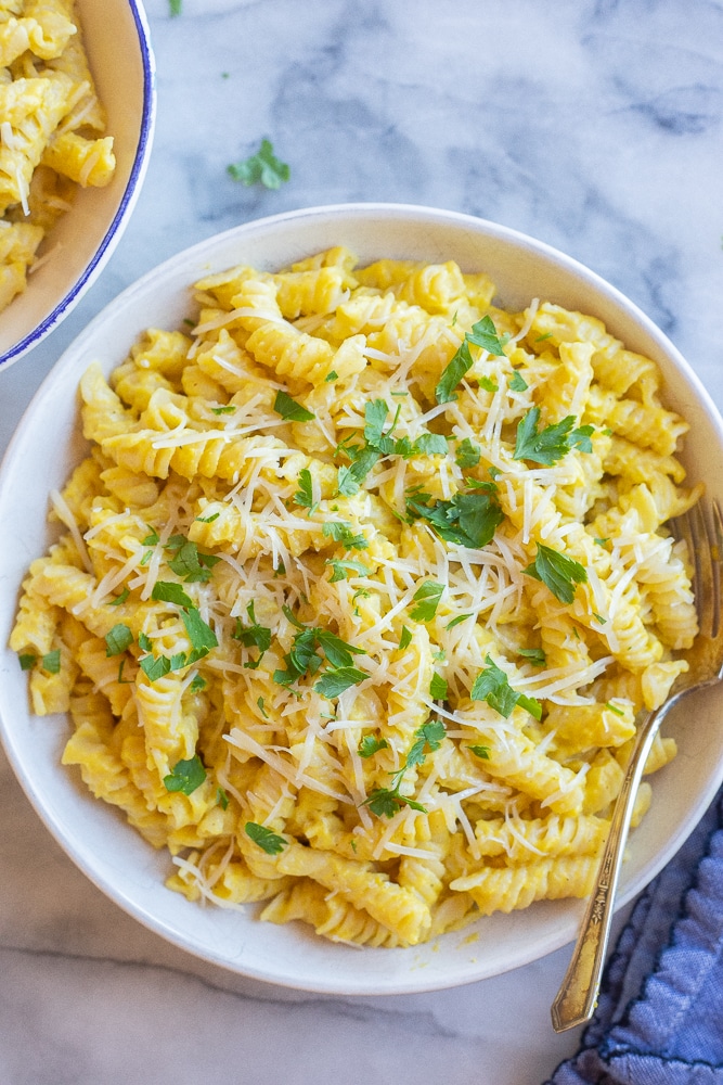 two bowls of golden summer squash pasta