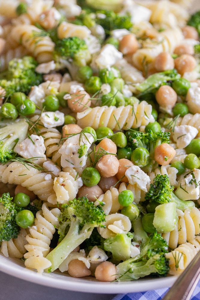 close up of a bowl of pasta salad with lemon, dill and feta cheese