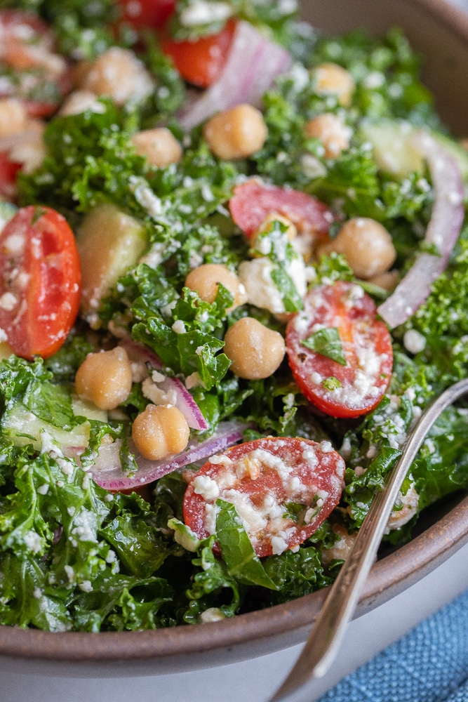 close up of lemon feta kale salad with cherry tomatoes