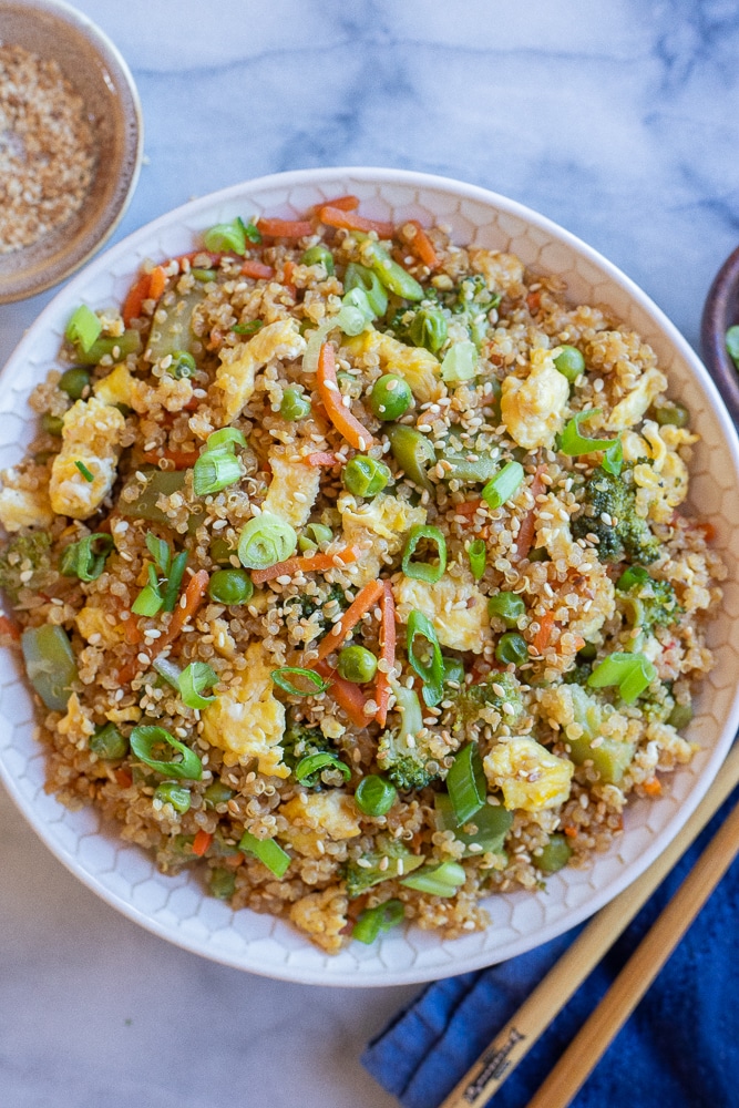 quinoa fried rice in a bowl with chopsticks