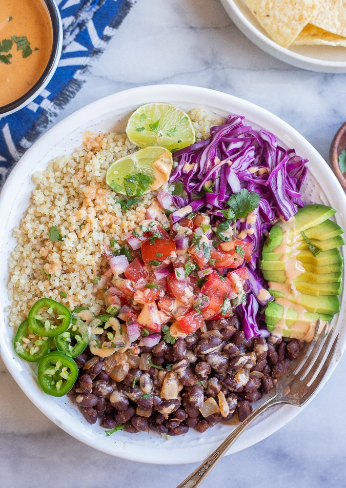black bean quinoa bowls with chipotle tahini sauce, avocado, purple cabbage and pico de Gallo