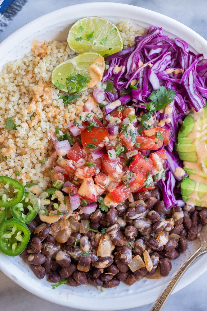 close up of a black bean quinoa bowl with lots of toppings