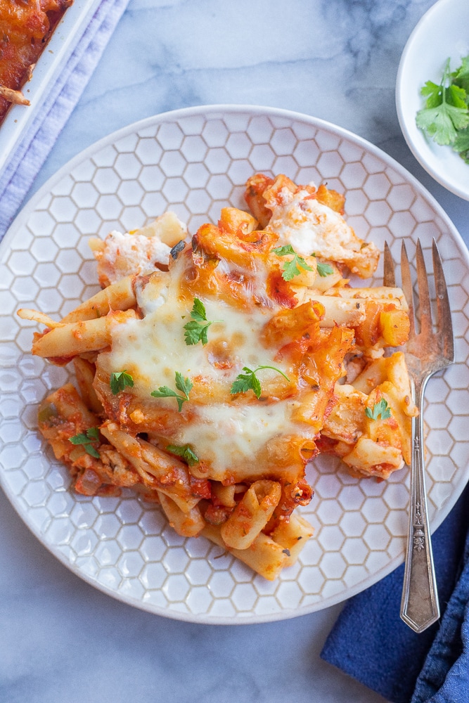 a plate of baked ziti with a fork