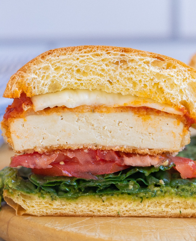 a vegetarian chicken parmesan sandwich cut in half