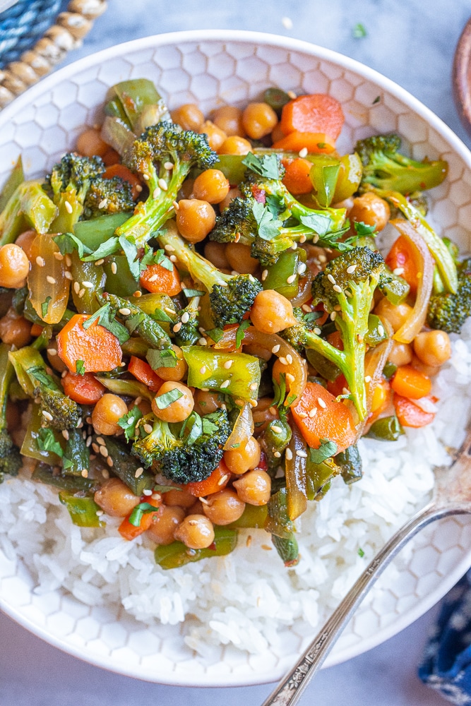 close up of chili garlic vegetable stir fry with chickpeas in a bowl
