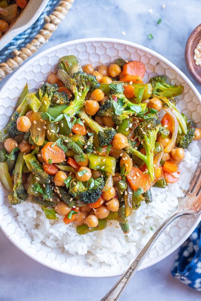 table setting with a bowl of garlic chili veggies with chickpeas