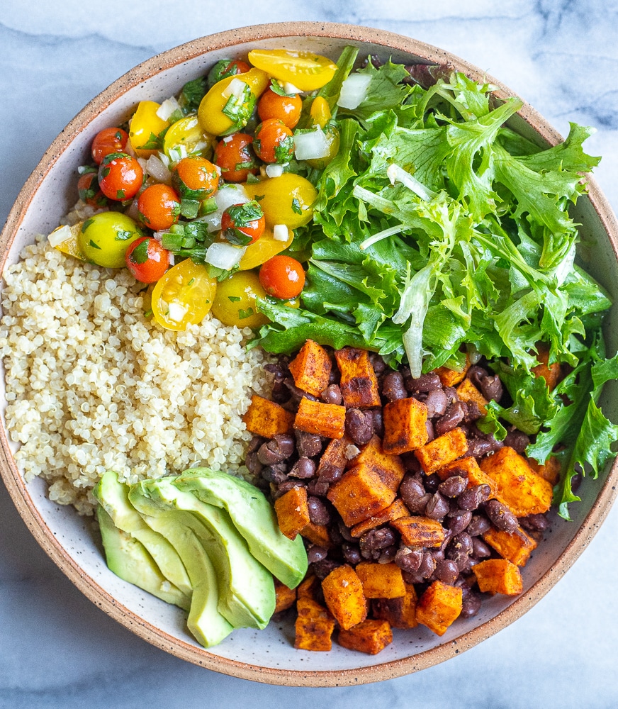 sweet potato quinoa bowls with black beans, pico de Gallo, lettuce and avocado in a bowl