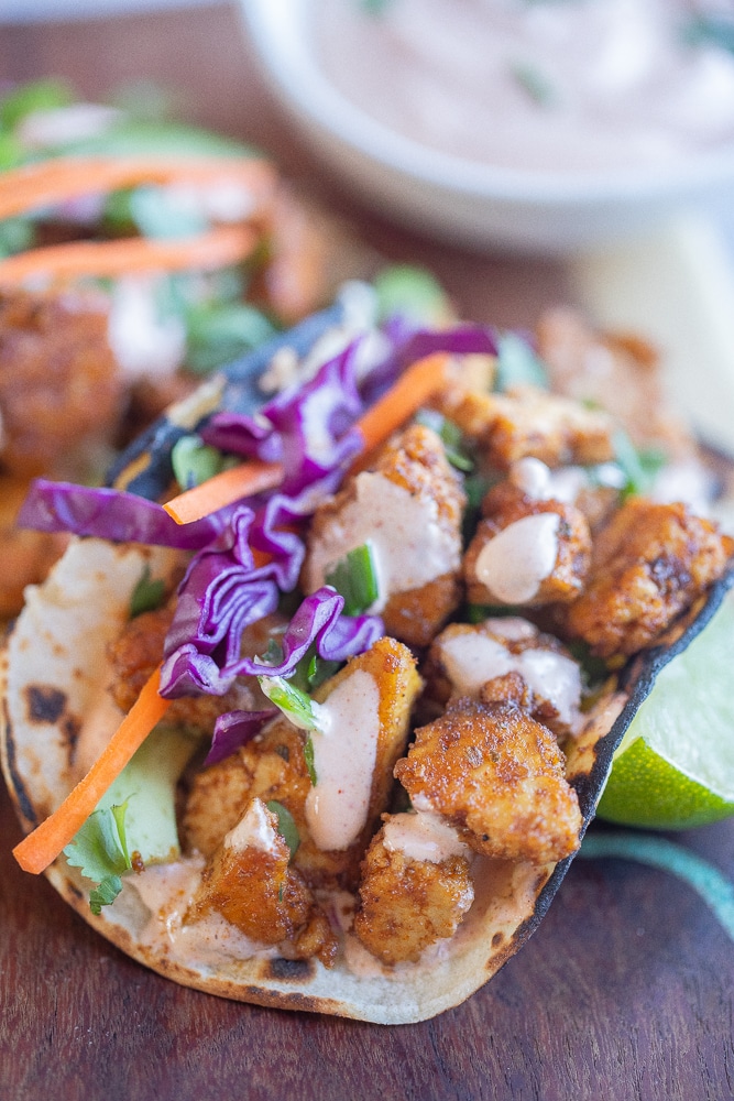 close up of a tofu fish taco with crispy veggies