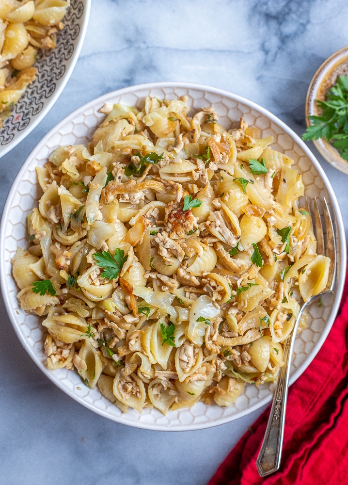 bowl of fried cabbage and noodles with crispy grated tofu