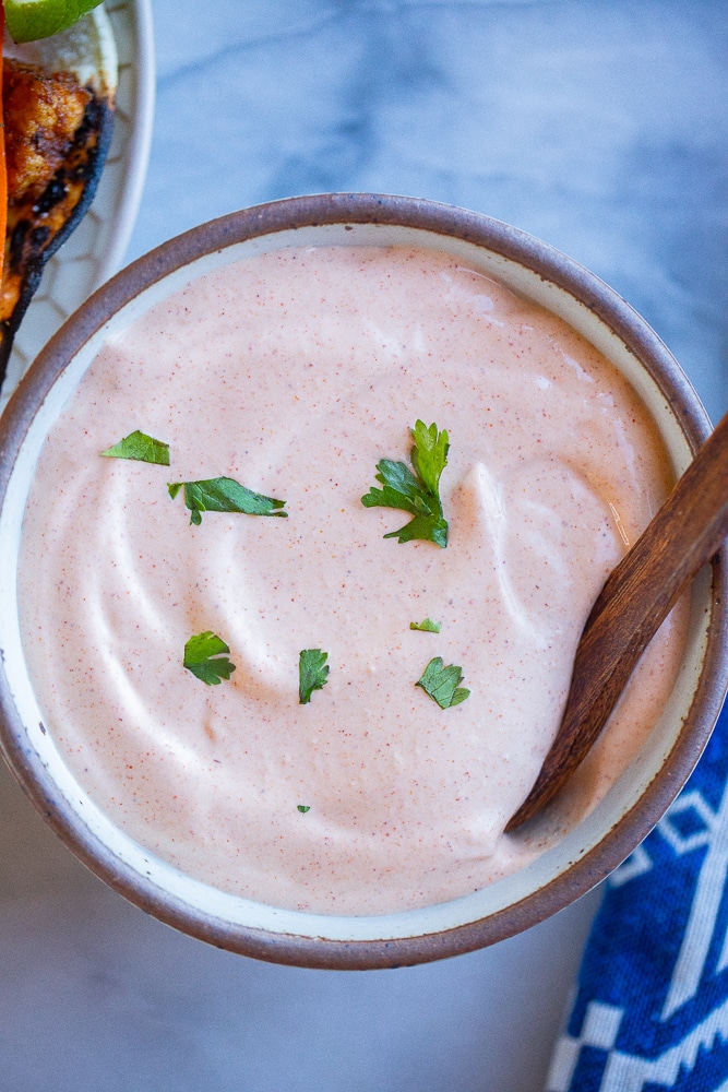 sour cream sauce in a serving bowl with a spoon