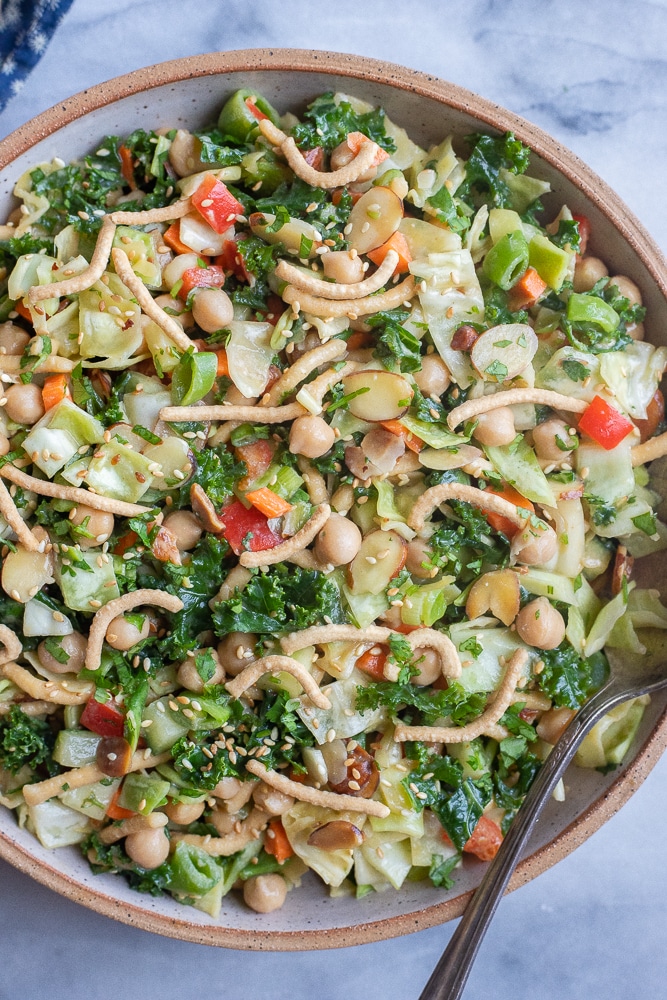 a large bowl of crunchy cabbage salad with chickpeas and kale