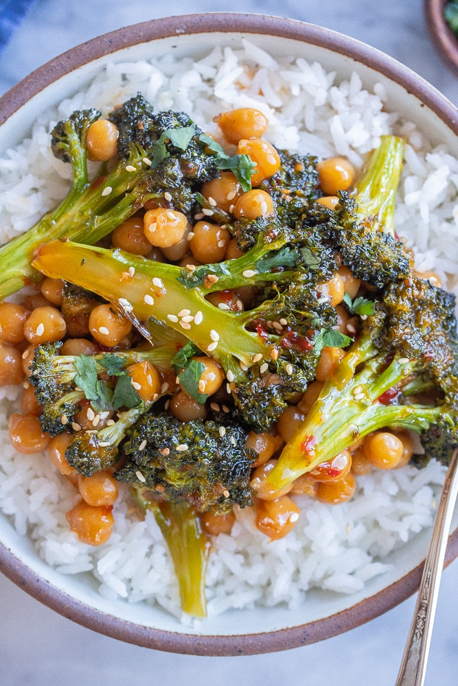 close up of chili garlic broccoli with chickpeas in a bowl with rice