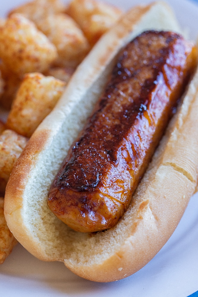 close up of a crispy vegetarian hot dog in a bun