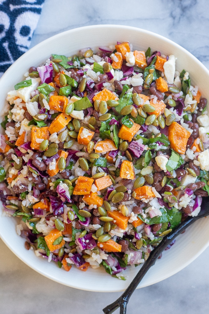 Healthy Halloween salad in a bowl with a skull and cross bones napkin