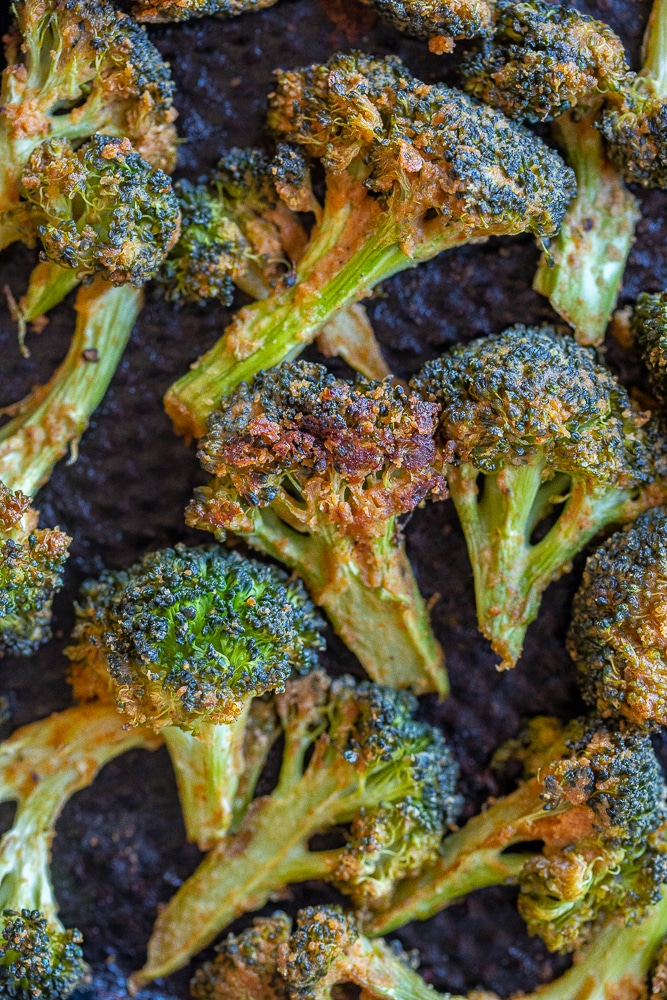 tahini roasted broccoli on a sheet pan out of the oven