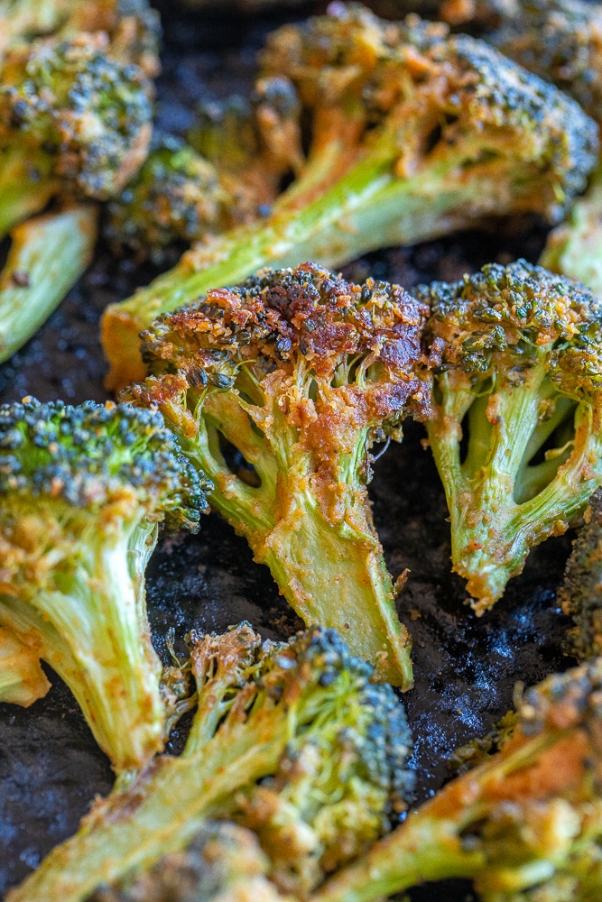 close up of tahini roasted broccoli on a sheet pan