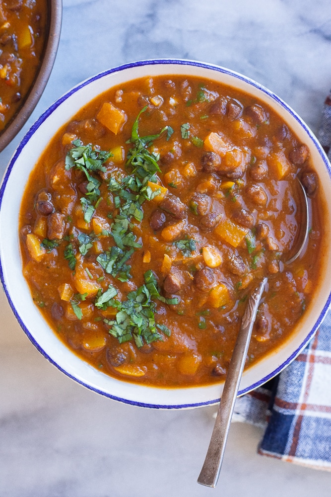 vegetarian pumpkin chili with black beans in a bowl topped with fresh cilantro