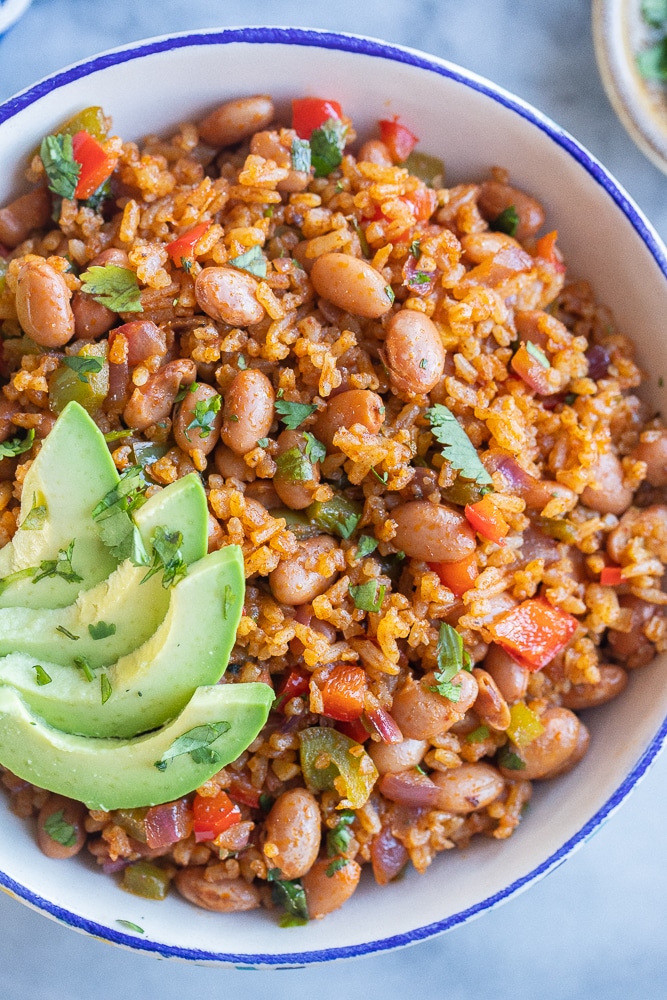 close up of a bowl of easy rice and bean stir fry with avocado