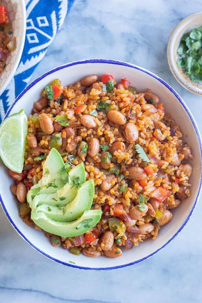 bowl of easy rice and bean stir fry in a bowl with avocado