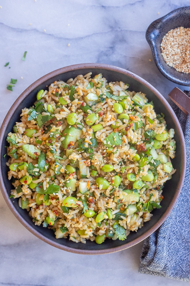 a black ceramic bowl full of Asian inspired rice salad