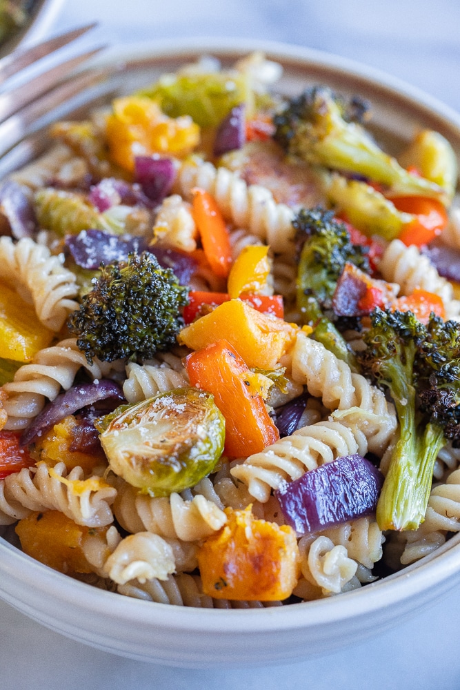 close up of a bowl of roasted veggie pasta with parmesan