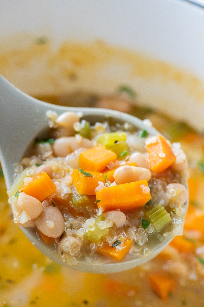 label full of hearty white bean soup with quinoa
