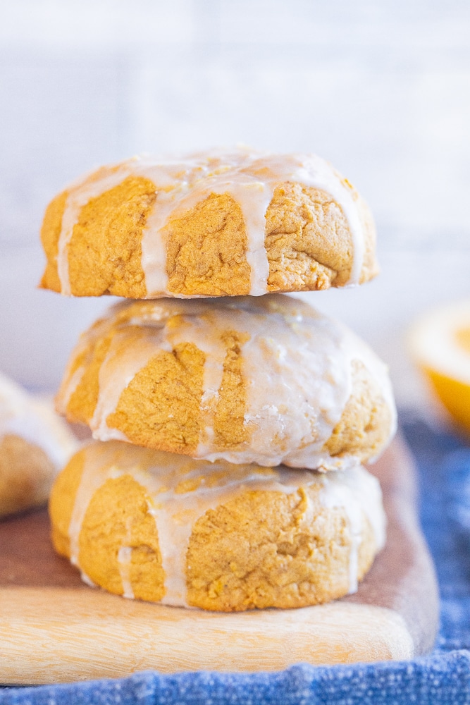 three soft pumpkin cookies stacked on top of each other
